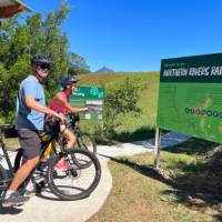 Couple on rail trail viewing Wollumbin | Kate Baker