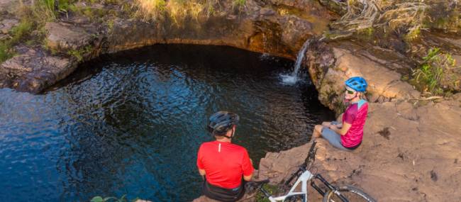Cycling rest stop by a waterfall in the Top End. | <i>Travis Deane</i>