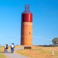 Cycling past the Rutherglen Wine Bottle on the Murray to Mountains Rail Trail | Ride High Country