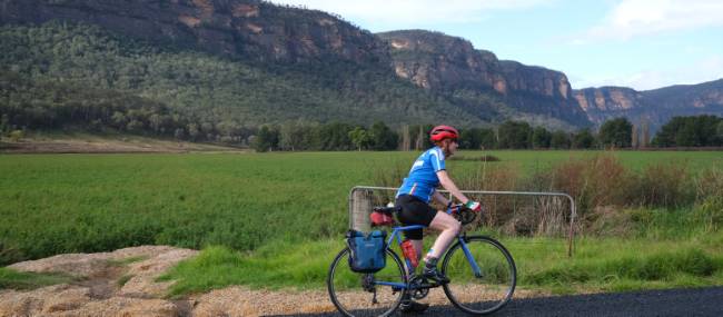 Cyclist passing the impressive escarpment of the Capertee Valley | Ross Baker