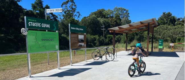 Stokers Siding with child cycling past | Kate Baker